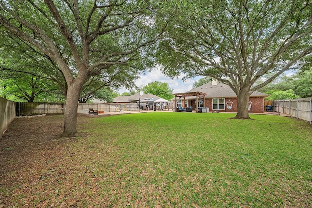 view of yard with a pergola and a fenced backyard