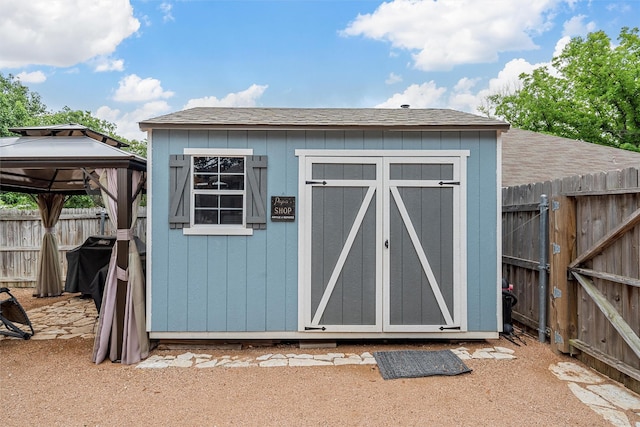 view of shed with a gazebo and fence