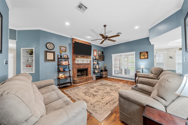 living area with crown molding, ceiling fan, recessed lighting, wood finished floors, and visible vents