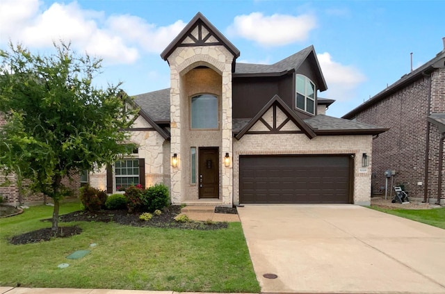 view of front of home featuring a front yard, stone siding, roof with shingles, brick siding, and concrete driveway