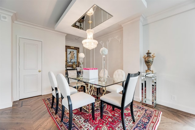 dining space with crown molding, baseboards, and an inviting chandelier