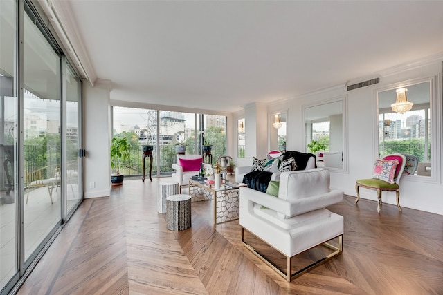 living room featuring visible vents, baseboards, and crown molding