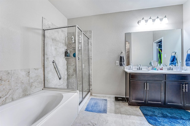 bathroom featuring a sink, a shower stall, a garden tub, and double vanity