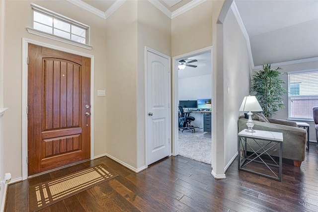 foyer featuring arched walkways, ornamental molding, baseboards, vaulted ceiling, and dark wood-style floors
