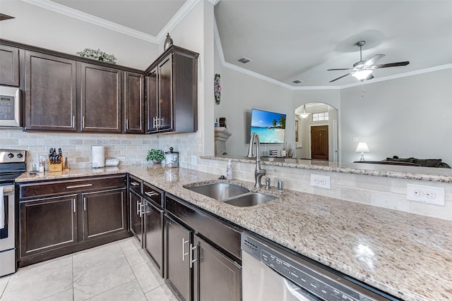 kitchen featuring a ceiling fan, visible vents, appliances with stainless steel finishes, a sink, and light stone counters