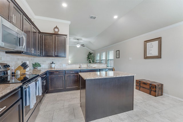 kitchen featuring crown molding, ceiling fan, stainless steel appliances, a kitchen island, and visible vents
