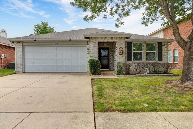 single story home featuring driveway, a front yard, central air condition unit, an attached garage, and a shingled roof