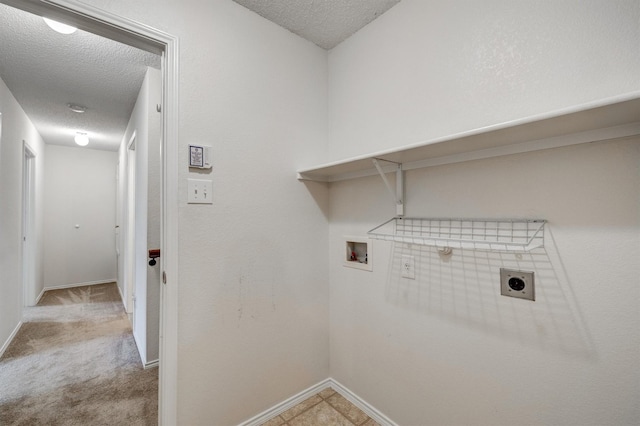 clothes washing area featuring a textured ceiling, electric dryer hookup, washer hookup, and laundry area