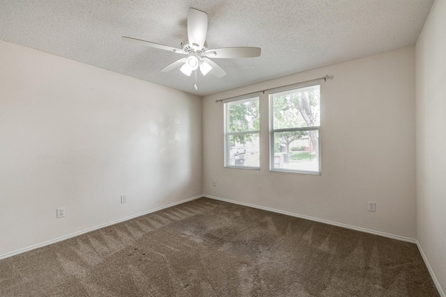 carpeted spare room featuring a ceiling fan, a textured ceiling, and baseboards