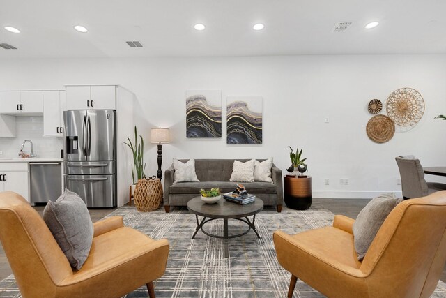 living area with baseboards, recessed lighting, and visible vents