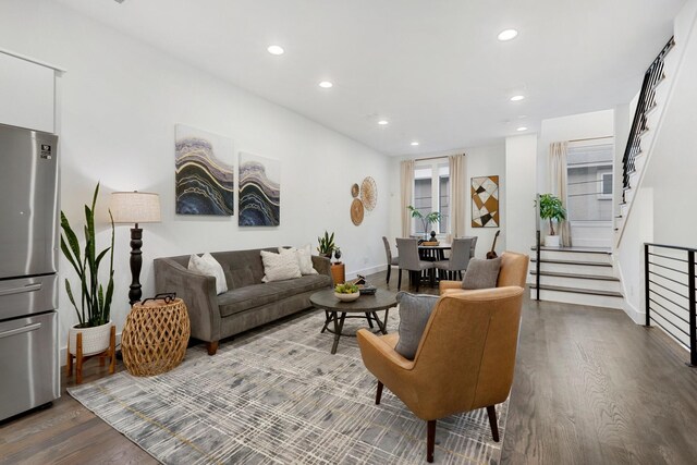 living area featuring recessed lighting, baseboards, stairs, and wood finished floors