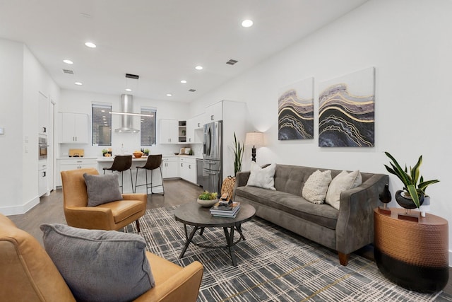 living area featuring baseboards, visible vents, recessed lighting, and dark wood-type flooring