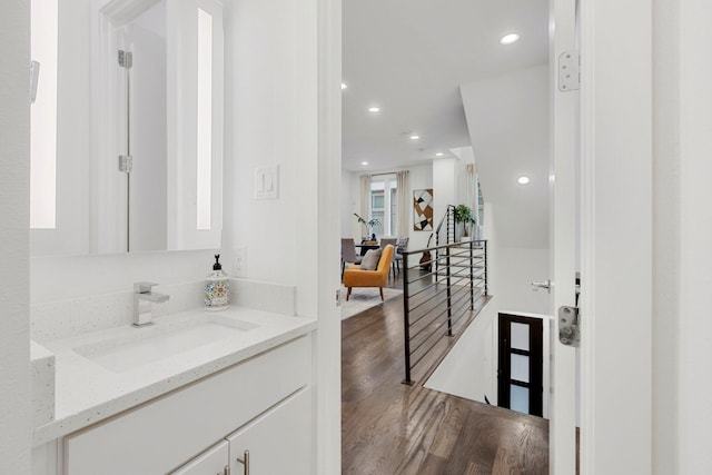 interior space featuring recessed lighting, wood finished floors, and vanity