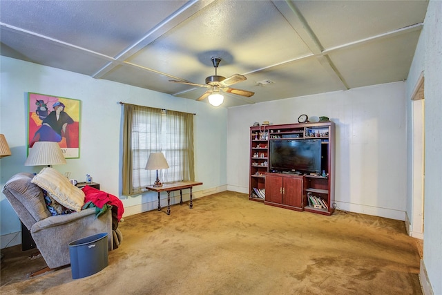 living area with carpet, a ceiling fan, baseboards, visible vents, and coffered ceiling