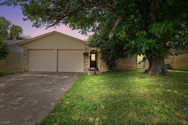 view of front of property with brick siding, an attached garage, driveway, and a front yard