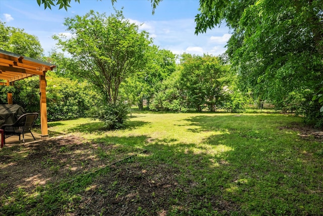 back of property with brick siding, a pergola, and a lawn