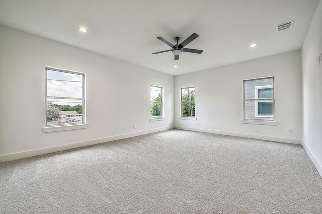 spare room featuring visible vents, baseboards, recessed lighting, a ceiling fan, and carpet