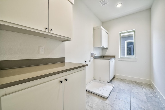 washroom with visible vents, cabinet space, baseboards, and hookup for an electric dryer