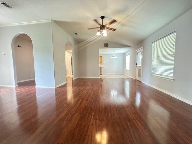 unfurnished living room featuring ceiling fan, arched walkways, baseboards, wood finished floors, and visible vents