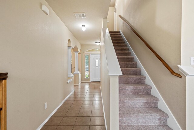 6728 Tierra Dr, Woodway, TX 76712 - stairs with arched walkways, tile patterned floors, baseboards, decorative columns, and visible vents