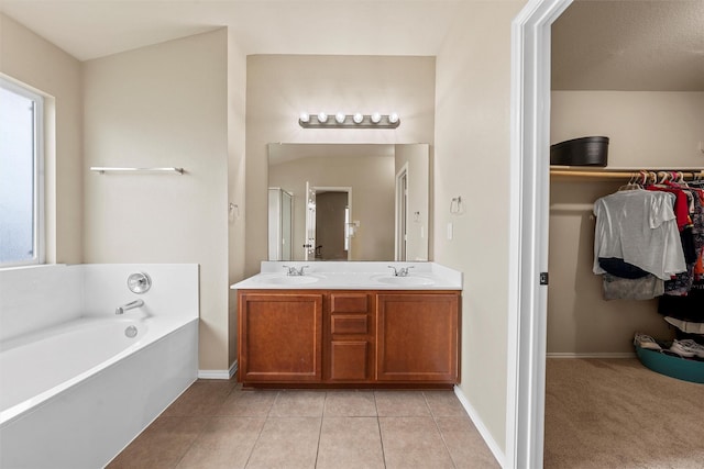 6728 Tierra Dr, Woodway, TX 76712 - full bath featuring double vanity, tile patterned floors, a sink, and a bath