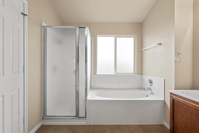 6728 Tierra Dr, Woodway, TX 76712 - full bathroom with vanity, tile patterned flooring, a garden tub, and a shower stall