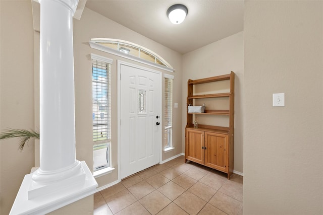 6728 Tierra Dr, Woodway, TX 76712 - foyer with ornate columns, baseboards, and light tile patterned floors
