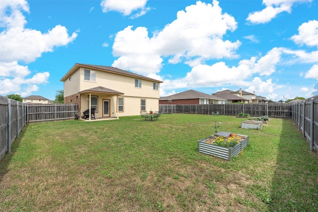 6728 Tierra Dr, Woodway, TX 76712 - rear view of house with a lawn, a fenced backyard, a garden, and stucco siding