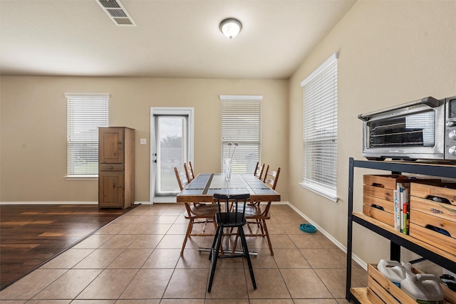 6728 Tierra Dr, Woodway, TX 76712 - tiled dining room featuring a healthy amount of sunlight, baseboards, a toaster, and visible vents