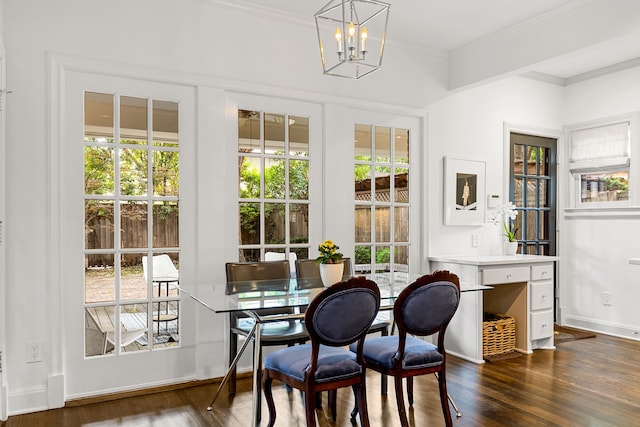 dining area featuring crown molding, an inviting chandelier, and dark wood-type flooring