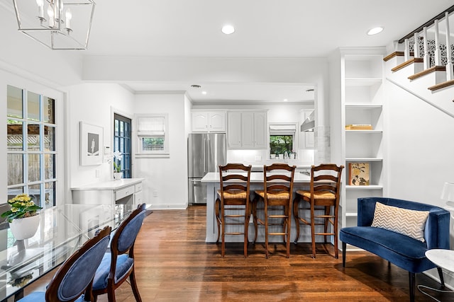 dining space featuring recessed lighting, ornamental molding, dark wood-style flooring, and a wealth of natural light