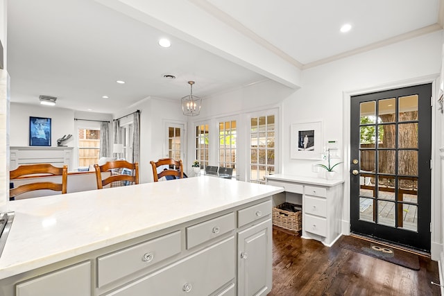 kitchen featuring crown molding, light countertops, recessed lighting, and dark wood-style flooring