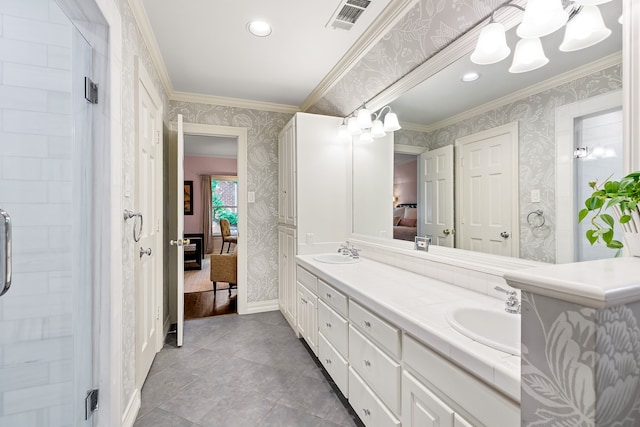 ensuite bathroom featuring a sink, ensuite bathroom, wallpapered walls, and crown molding