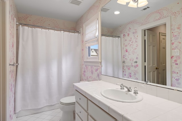 bathroom with visible vents, tile patterned flooring, vanity, and wallpapered walls