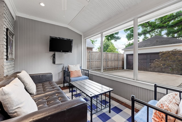 sunroom with an outdoor living space with a fireplace and ceiling fan