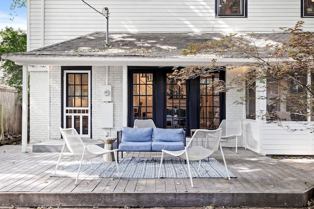 wooden terrace featuring outdoor lounge area and french doors