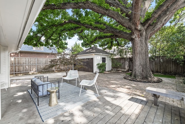wooden deck featuring an outbuilding and a fenced backyard