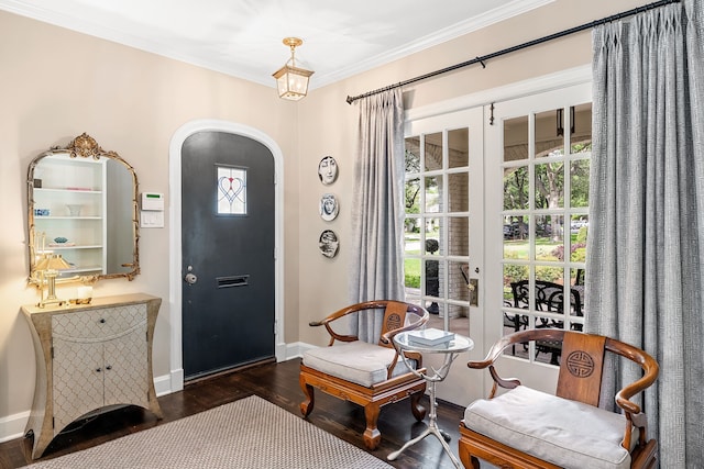 living area with baseboards, arched walkways, wood finished floors, and a wealth of natural light