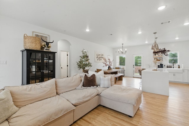 2312 Neches St, Granbury, TX 76048 - living area with light wood finished floors, arched walkways, a chandelier, recessed lighting, and visible vents