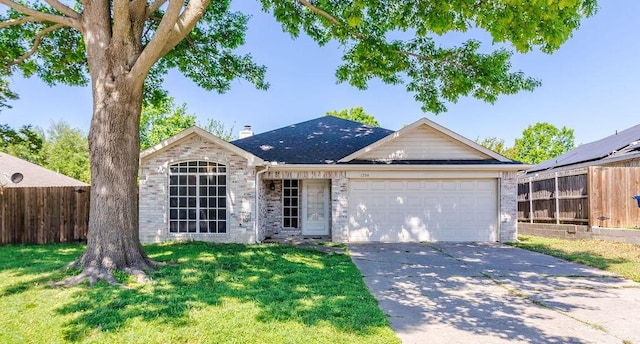 ranch-style house featuring concrete driveway, fence, a front yard, and a garage