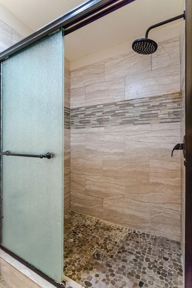 bathroom with tiled shower