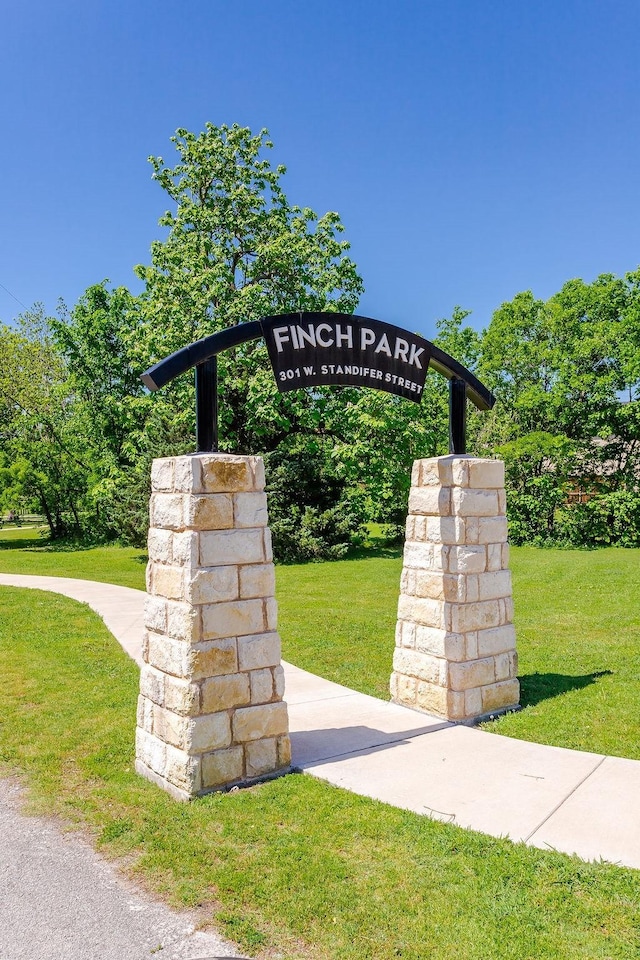 community / neighborhood sign with a lawn