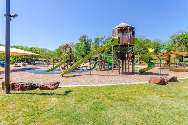 community jungle gym with a lawn