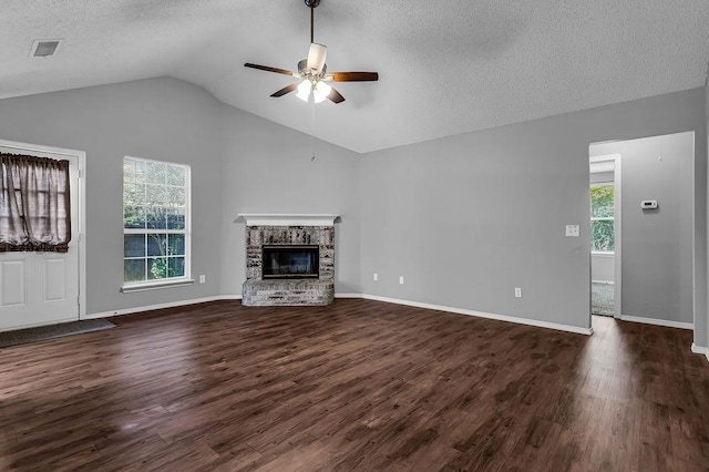 unfurnished living room featuring dark wood-style flooring, ceiling fan, visible vents, and a textured ceiling