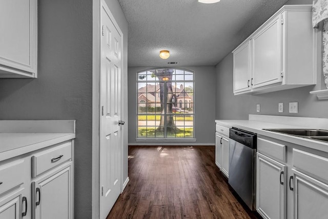 kitchen featuring dishwasher, light countertops, a textured ceiling, white cabinetry, and dark wood-type flooring