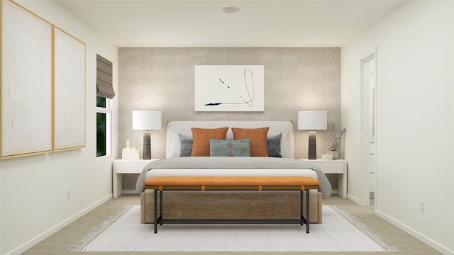 bedroom featuring baseboards and light carpet