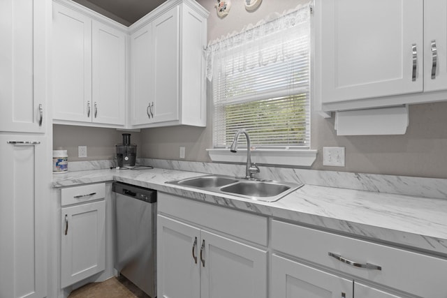 kitchen with a sink, white cabinetry, and dishwasher