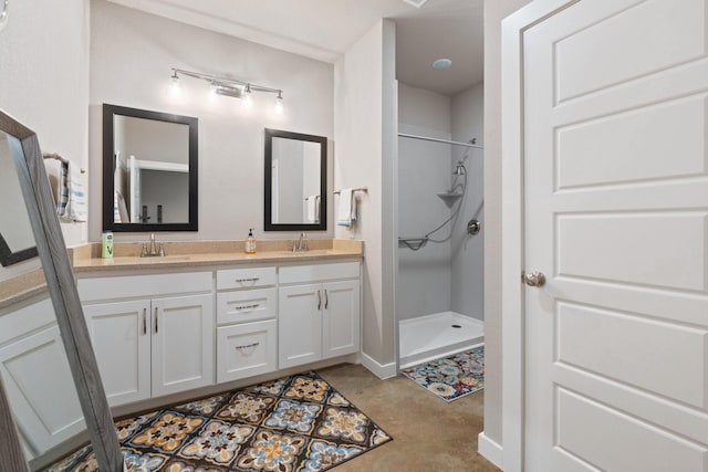 full bathroom with double vanity, a sink, and a stall shower