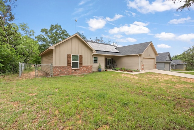 single story home with board and batten siding, brick siding, concrete driveway, and a gate