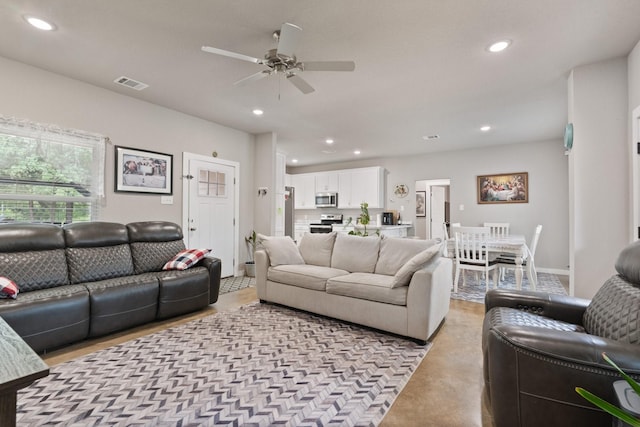living room with ceiling fan, recessed lighting, and visible vents